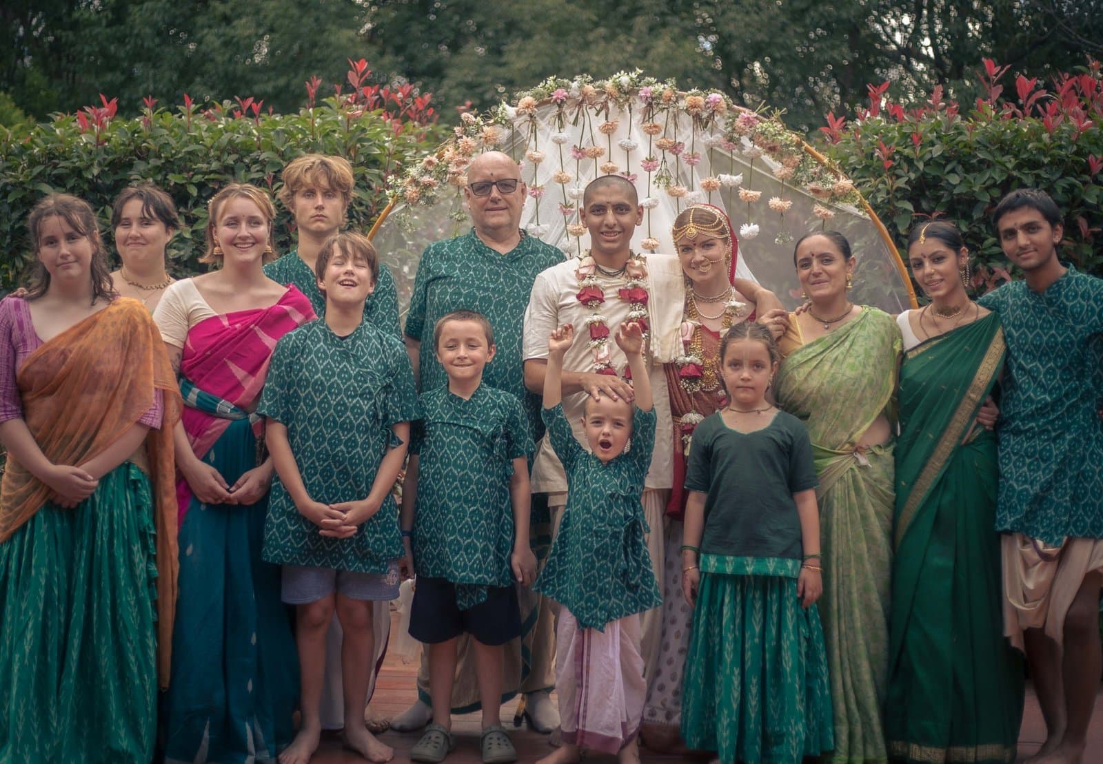 The family behind Lucid Pure Vegetarian, gathered under a floral arch